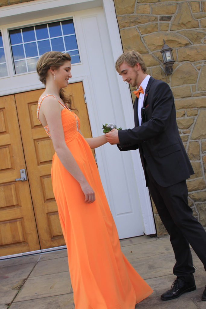 Marcus putting on Stephanie's Corsage
